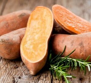 Patates douces présentées avec du pain et sur une table en bois